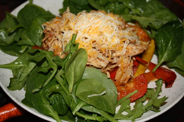 the chicken filling, over sauteed peppers, yellow squash and served with greens and some cheese